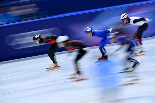 Italy's Pietro Sighel (C) competes to win gold in the short track speed skating mixed team relay final during the Milano Cortina 2026 Winter Olympic Games at Milano Ice Skating Arena in Milan on February 10, 2026. (Photo by WANG Zhao / AFP)