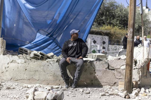 Residents of the al-Bustan area of the Palestinian neighbourhood of Silwan, in Israeli-annexed east Jerusalem, watch as Israeli authorities demolish structures on February 10, 2026. (Photo by ilia YEFIMOVICH / AFP)