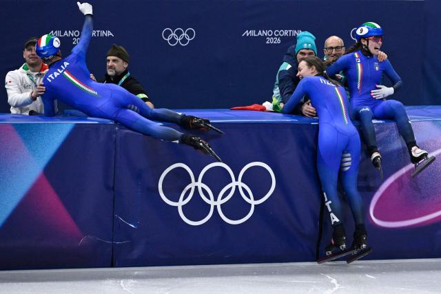 Team Italy celebrate after winning gold in the short track speed skating mixed team relay final during the Milano Cortina 2026 Winter Olympic Games at Milano Ice Skating Arena in Milan on February 10, 2026. (Photo by WANG Zhao / AFP)