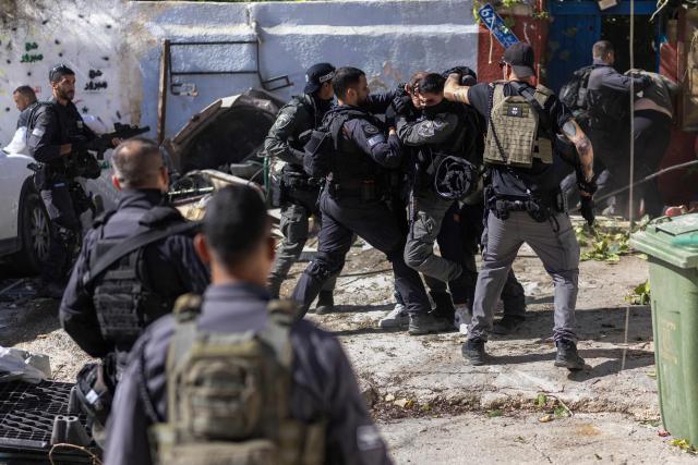 Israeli police scuffle with Palestinian residents during the demolition of structures in in the al-Bustan area of the Palestinian neighbourhood of Silwan, in Israeli-annexed east Jerusalem, on February 10, 2026. (Photo by ilia YEFIMOVICH / AFP)