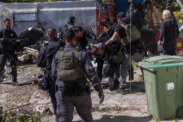 Israeli police scuffle with Palestinian residents during the demolition of structures in in the al-Bustan area of the Palestinian neighbourhood of Silwan, in Israeli-annexed east Jerusalem, on February 10, 2026. (Photo by ilia YEFIMOVICH / AFP)
