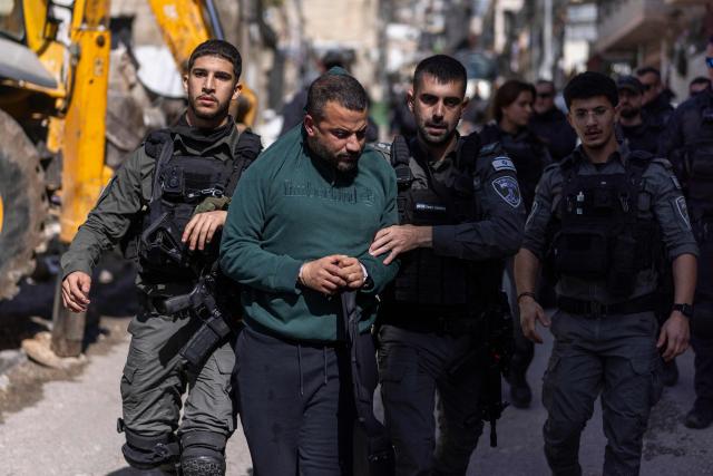 Israeli security forces detain a Palestinian man during the demolition of structures in the al-Bustan area of the Palestinian neighbourhood of Silwan, in Israeli-annexed east Jerusalem, on February 10, 2026. (Photo by ilia YEFIMOVICH / AFP)