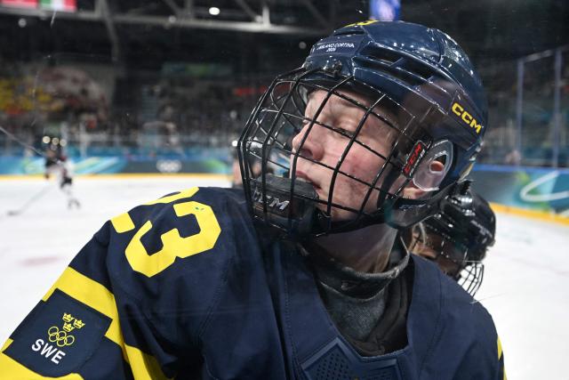 Sweden's #23 Thea Johansson gets pushed into the barrier during the women's preliminary round Group B Ice Hockey match between Japan and Sweden at the Milano Rho Ice Hockey Arena at the Milano Cortina 2026 Winter Olympic Games in Milan, on February 10, 2026. (Photo by PIERO CRUCIATTI / AFP)