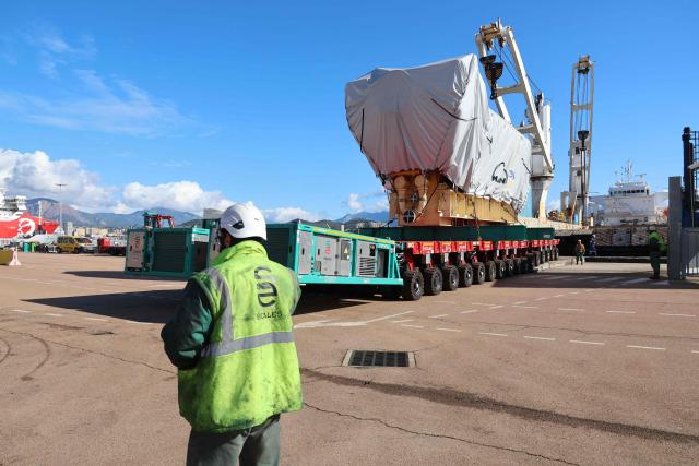 Workers unload a biofuel engine from a bunkering vessel at the Ajaccio's port prior to their installation at the new Ajaccio's Ricanto electric central, in Ajaccio on the French Mediterranean island of Corsica on February 10, 2026. (Photo by Pascal POCHARD-CASABIANCA / AFP)