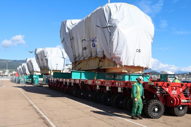 Workers unload a biofuel engine from a bunkering vessel at the Ajaccio's port prior to their installation at the new Ajaccio's Ricanto electric central, in Ajaccio on the French Mediterranean island of Corsica on February 10, 2026. (Photo by Pascal POCHARD-CASABIANCA / AFP)