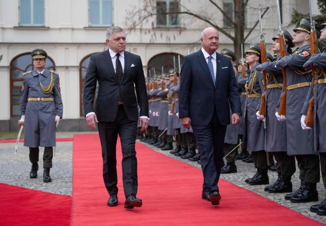 Slovakia's Prime Minister Robert Fico (L) and Austria's Chancellor Christian Stocker review a military honor guard during a welcoming ceremony prior to the so-called S3 (Slavkov format) meeting with Czech Prime Minister in Bratislava, Slovakia, on February 10, 2026. (Photo by Joe Klamar / AFP)