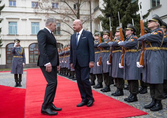 Slovakia's Prime Minister Robert Fico (L) and Austria's Chancellor Christian Stocker review a military honor guard during a welcoming ceremony prior to the so-called S3 (Slavkov format) meeting with Czech Prime Minister in Bratislava, Slovakia, on February 10, 2026. (Photo by Joe Klamar / AFP)