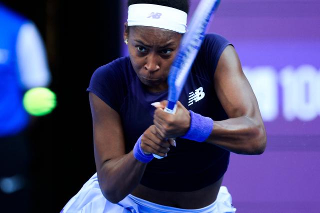 US' Coco Gauff hits a return against Italy's Elisabetta Cocciaretto during  their women’s singles match at the Qatar Open tennis tournament in Doha on February 10, 2026. (Photo by Karim JAAFAR / AFP)