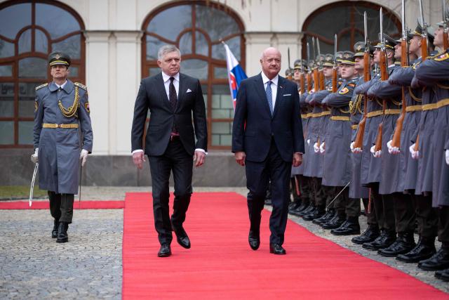 Slovakia's Prime Minister Robert Fico (L) and Austria's Chancellor Christian Stocker review a military honor guard during a welcoming ceremony prior to the so-called S3 (Slavkov format) meeting with Czech Prime Minister in Bratislava, Slovakia, on February 10, 2026. (Photo by Joe Klamar / AFP)