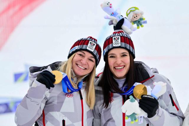 Gold medallists Austria's Ariane Raedler (L) and Austria's Katharina Huber pose on the podium of the women's team combined event during the Milano Cortina 2026 Winter Olympic Games at the Tofane Alpine Skiing Centre in Cortina d’Ampezzo on February 10, 2026. (Photo by Stefano RELLANDINI / AFP)