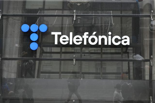 (FILES) This photograph shows the logo of Telefonica at the company's headquarters in Madrid on December 4, 2023. Spanish telecoms giant Telefonica, in the midst of restructuring and facing heavy debt, announced on February 10, 2026 that it had sold its subsidiary in Chile for 1 billion euros, continuing its disengagement from Latin America. (Photo by JAVIER SORIANO / AFP)