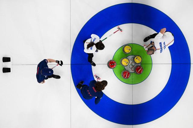 Italy's Amos Mosaner and Italy's Stefania Constantini compete in the curling mixed doubles round robin bronze medal game between Great Britain and Italy during the Milano Cortina 2026 Winter Olympic Games at the Cortina Curling Olympic Stadium in Cortina d’Ampezzo on February 10, 2026. (Photo by Franзois-Xavier MARIT / AFP)