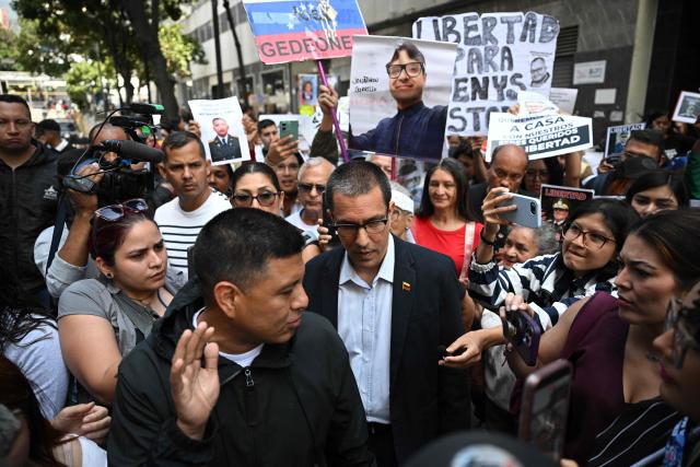 The President of the Parliamentary Amnesty Commission Jorge Arreaza (C) talks with relatives of political prisoners demonstrating in front of the national parliament building in Caracas on February 10, 2026. (Photo by Federico PARRA / AFP)