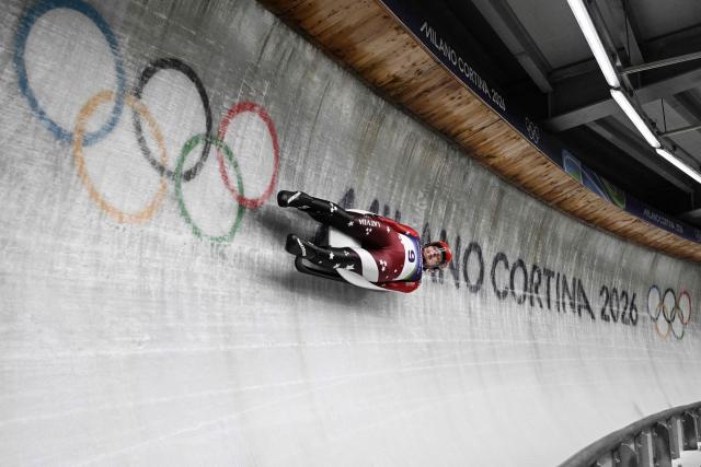 Latvia's Kendija Aparjode competes in the luge women's singles run 3 at Cortina Sliding Centre during the Milano Cortina 2026 Winter Olympic Games in Cortina d'Ampezzo on February 10, 2026. (Photo by Tiziana FABI / AFP)