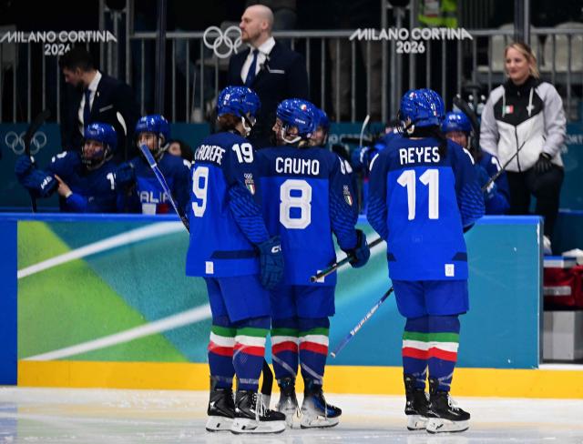 Italy's #11 Justine Reyes (R) celebrates scoring the 1-0 goal with team mates during the women's preliminary round Group B Ice Hockey match between Italy and Germany at the Milano Rho Ice Hockey Arena at the Milano Cortina 2026 Winter Olympic Games in Milan, on February 10, 2026. (Photo by Piero CRUCIATTI / AFP)