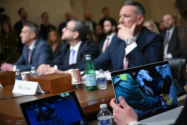 (L/R) Rodney Scott, Commissioner of US Customs and Border Protection (CBP), Joseph Edlow, Director of US Citizenship and Immigration Services (USCIS), and Todd Lyons, acting director of US Immigration and Customs Enforcement (ICE), look at a TV screen as they testify during a House Committee on Homeland Security hearing on Oversight of the Department of Homeland Security on Capitol Hill in Washington, DC, on February 10, 2026. (Photo by ANDREW CABALLERO-REYNOLDS / AFP)