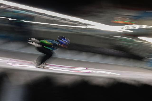 Japan's Ryoyu Kobayashi slides down the inrun track during the ski jumping mixed team trial round of the Milano Cortina 2026 Winter Olympic Games at Predazzo Ski Jumping Stadium in Predazzo (Val di Fiemme), on February 10, 2026. (Photo by Anne-Christine POUJOULAT / AFP)