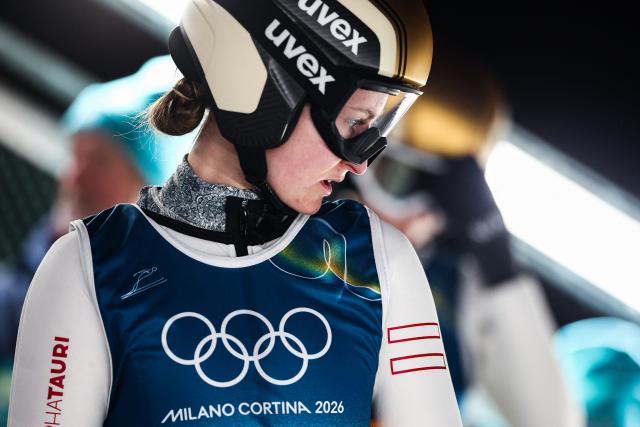 Austria's Julia Muehlbacher reacts prior to jumping during the ski jumping mixed team trial round of the Milano Cortina 2026 Winter Olympic Games at Predazzo Ski Jumping Stadium in Predazzo (Val di Fiemme), on February 10, 2026. (Photo by Anne-Christine POUJOULAT / AFP)