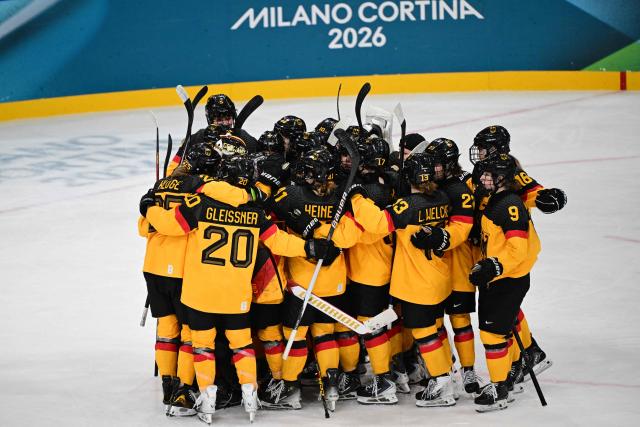 Germany's players celebrate winning the women's preliminary round Group B Ice Hockey match between Italy and Germany at the Milano Rho Ice Hockey Arena at the Milano Cortina 2026 Winter Olympic Games in Milan, on February 10, 2026. Germany won the match 2-1. (Photo by Piero CRUCIATTI / AFP)