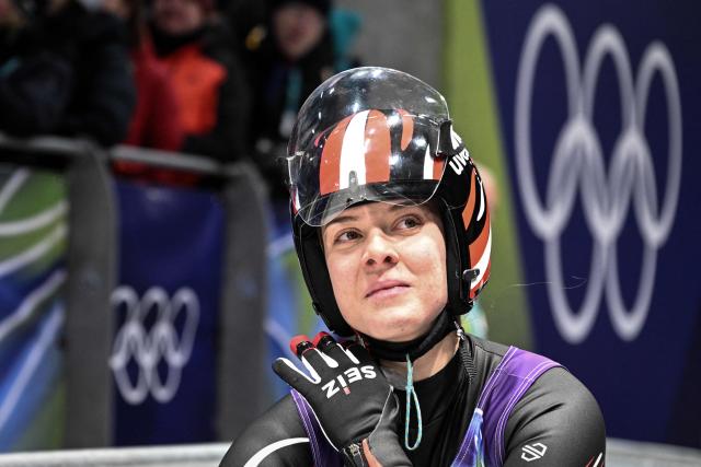 Austria's Lisa Schulte reacts after crossing the finish line in the luge women's singles run 4 at Cortina Sliding Centre during the Milano Cortina 2026 Winter Olympic Games in Cortina d'Ampezzo on February 10, 2026. (Photo by Tiziana FABI / AFP)