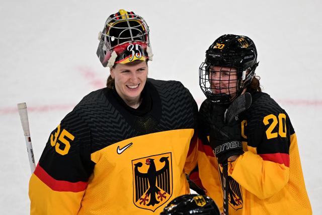 Germany's #35 Sandra Abstreiter (L) and Germany's #20 Daria Gleissner celebrate winning the women's preliminary round Group B Ice Hockey match between Italy and Germany at the Milano Rho Ice Hockey Arena at the Milano Cortina 2026 Winter Olympic Games in Milan, on February 10, 2026. Germany won the match 2-1. (Photo by Piero CRUCIATTI / AFP)