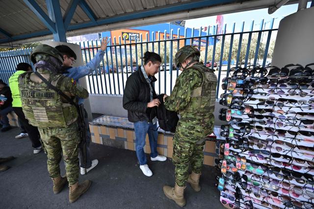 Military personnel carry out weapons and drug checks in Quito, on February 10, 2026, as part of the fight against crime. (Photo by Rodrigo BUENDIA / AFP)