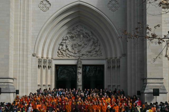 Buddhist monks arrive at the Washington National Cathedral in Washington, DC, on February 10, 2026 before taking part in an interfaith ceremony during the final days of their 2,300-mile "Walk for Peace". (Photo by Drew ANGERER / AFP)