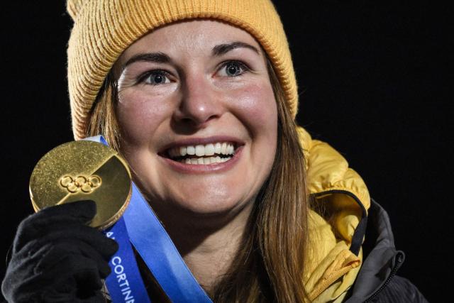 Gold medallist Germany's Julia Taubitz celebrates on the podium after competing in the luge women's singles at Cortina Sliding Centre during the Milano Cortina 2026 Winter Olympic Games in Cortina d'Ampezzo on February 10, 2026. (Photo by Tiziana FABI / AFP)