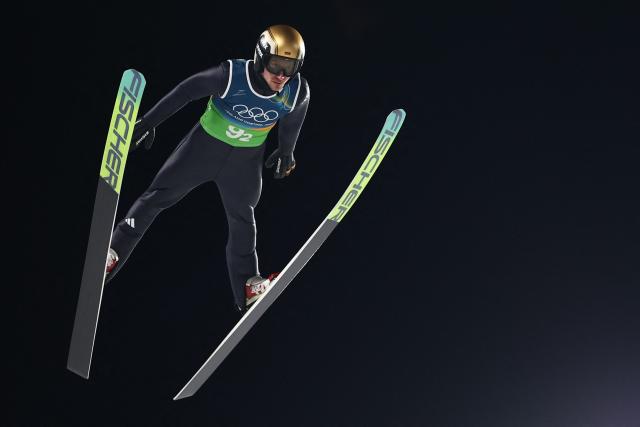 Germany's Felix Hoffmann jumps during the ski jumping mixed team final round of the Milano Cortina 2026 Winter Olympic Games at Predazzo Ski Jumping Stadium in Predazzo (Val di Fiemme), on February 10, 2026. (Photo by Anne-Christine POUJOULAT / AFP)