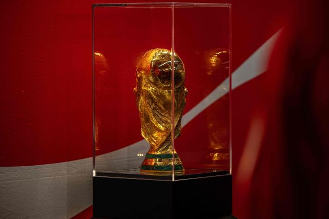 This photograph shows the 2026 FIFA World Cup trophy displayed during a public event at the Adidas store in Paris on February 10, 2026. (Photo by Guillaume BAPTISTE / AFP)