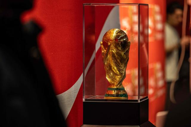This photograph shows the 2026 FIFA World Cup trophy displayed during a public event at the Adidas store in Paris on February 10, 2026. (Photo by Guillaume BAPTISTE / AFP)
