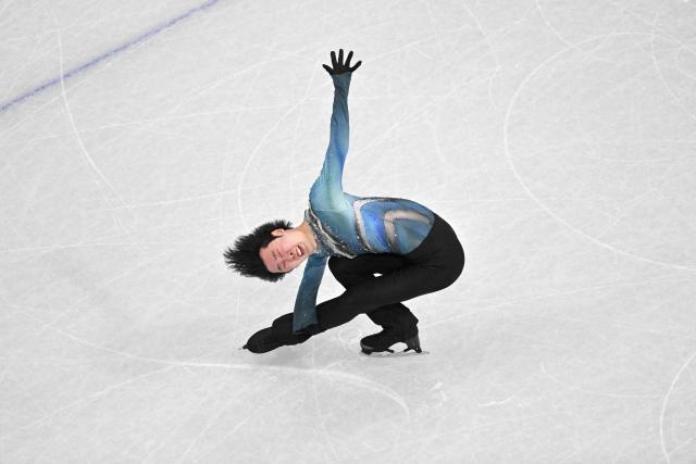 China's Jin Boyang competes in the figure skating men's singles short program during the Milano Cortina 2026 Winter Olympic Games at Milano Ice Skating Arena in Milan on February 10, 2026. (Photo by Antonin THUILLIER / AFP)