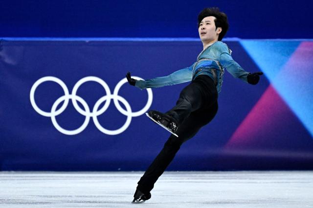 China's Jin Boyang competes in the figure skating men's singles short program during the Milano Cortina 2026 Winter Olympic Games at Milano Ice Skating Arena in Milan on February 10, 2026. (Photo by WANG Zhao / AFP)