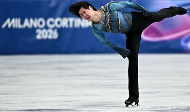 China's Jin Boyang competes in the figure skating men's singles short program during the Milano Cortina 2026 Winter Olympic Games at Milano Ice Skating Arena in Milan on February 10, 2026. (Photo by Gabriel BOUYS / AFP)