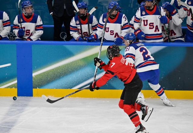Canada's forward #07 Laura Stacey (L) vies for the puck with USA's defender #02 Lee Stecklein  during the women's preliminary round Group A Ice Hockey match between Canada and USA at the Milano Santagiulia Ice Hockey Arena during the Milano Cortina 2026 Winter Olympic Games in Milan, on February 10, 2026. (Photo by Alexander NEMENOV / AFP)