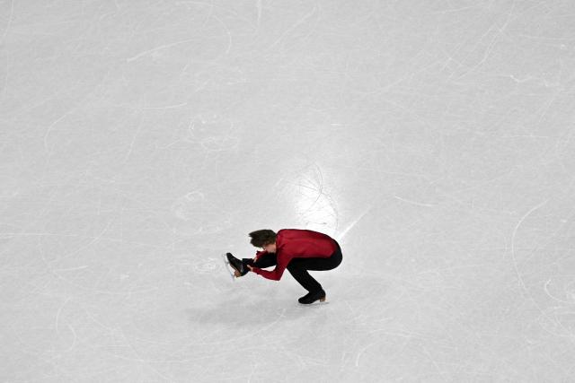 Latvia's Deniss Vasiljevs competes in the figure skating men's singles short program during the Milano Cortina 2026 Winter Olympic Games at Milano Ice Skating Arena in Milan on February 10, 2026. (Photo by Antonin THUILLIER / AFP)