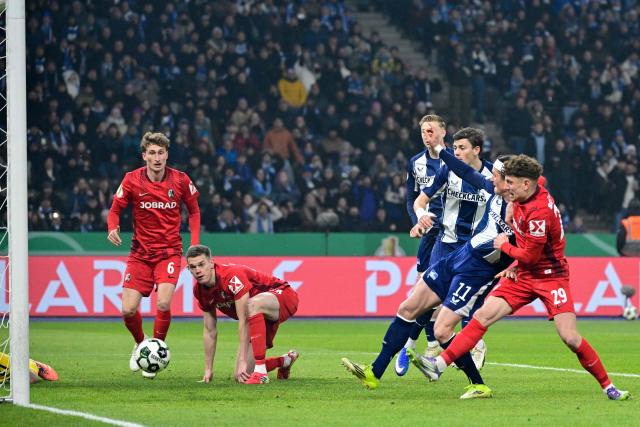 Hertha Berlin's German forward #11 Fabian Reese (2nd R) scores a goal which was disallowed for offside by VAR during the German Cup (DFB-Pokal) quarter-final football match between Hertha Berlin and SC Freiburg in Berlin on February 10, 2026. (Photo by John MACDOUGALL / AFP) / DFB REGULATIONS PROHIBIT ANY USE OF PHOTOGRAPHS AS IMAGE SEQUENCES AND QUASI-VIDEO.