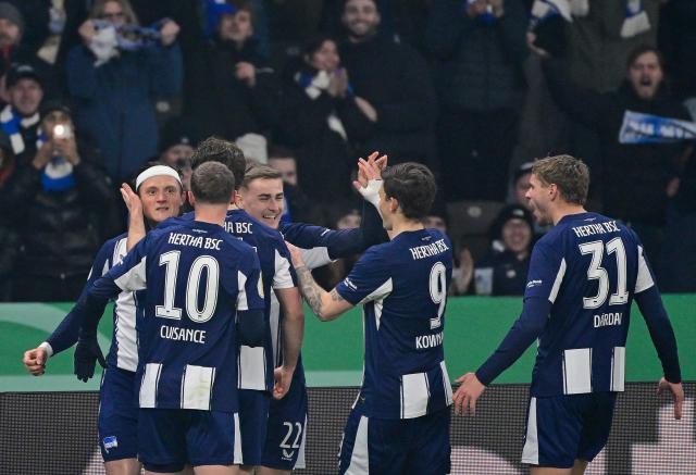 Hertha Berlin's German forward #11 Fabian Reese (L) celebrates scoring with his teammates before the goal was disallowed for offside by VAR during the German Cup (DFB-Pokal) quarter-final football match between Hertha Berlin and SC Freiburg in Berlin on February 10, 2026. (Photo by John MACDOUGALL / AFP) / DFB REGULATIONS PROHIBIT ANY USE OF PHOTOGRAPHS AS IMAGE SEQUENCES AND QUASI-VIDEO.