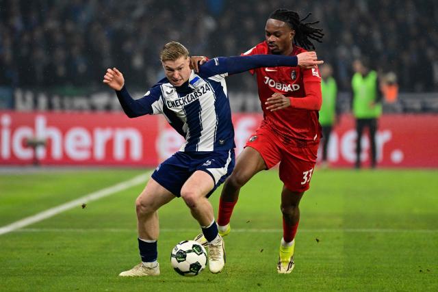 Hertha Berlin's German midfielder #02 Julian Eitschberger (L) and Freiburg's French defender #33 Jordy Makengo vie for the ball during the German Cup (DFB-Pokal) quarter-final football match between Hertha Berlin and SC Freiburg in Berlin on February 10, 2026. (Photo by John MACDOUGALL / AFP) / DFB REGULATIONS PROHIBIT ANY USE OF PHOTOGRAPHS AS IMAGE SEQUENCES AND QUASI-VIDEO.