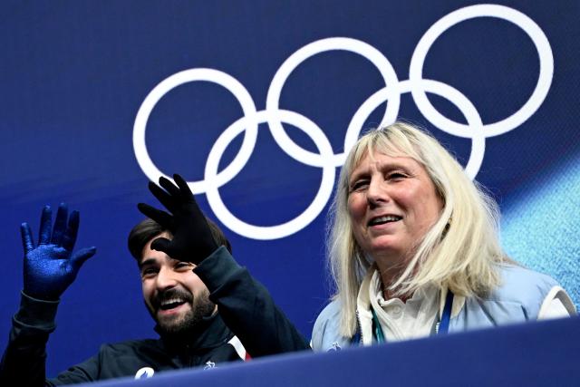 France's Kevin Aymoz reacts at the kiss and cry area after competing in the figure skating men's singles short program during the Milano Cortina 2026 Winter Olympic Games at Milano Ice Skating Arena in Milan on February 10, 2026. (Photo by WANG Zhao / AFP)