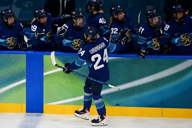 Finland's #24 Viivi Vainikka (front) celebrates scoring her team's first goal with team mates during the women's preliminary round Group A Ice Hockey match between Finland and Switzerland at the Milano Rho Ice Hockey Arena during the Milano Cortina 2026 Winter Olympic Games in Milan, on February 10, 2026. (Photo by Piero CRUCIATTI / AFP)