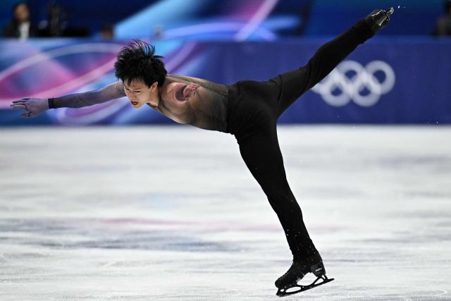 France's Adam Siao Him Fa competes in the figure skating men's singles short program during the Milano Cortina 2026 Winter Olympic Games at Milano Ice Skating Arena in Milan on February 10, 2026. (Photo by Gabriel BOUYS / AFP)