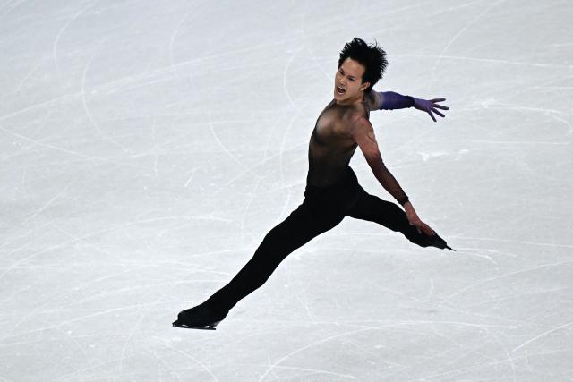 France's Adam Siao Him Fa competes in the figure skating men's singles short program during the Milano Cortina 2026 Winter Olympic Games at Milano Ice Skating Arena in Milan on February 10, 2026. (Photo by JULIEN DE ROSA / AFP)