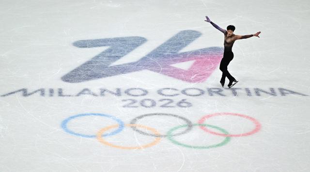 France's Adam Siao Him Fa competes in the figure skating men's singles short program during the Milano Cortina 2026 Winter Olympic Games at Milano Ice Skating Arena in Milan on February 10, 2026. (Photo by JULIEN DE ROSA / AFP)