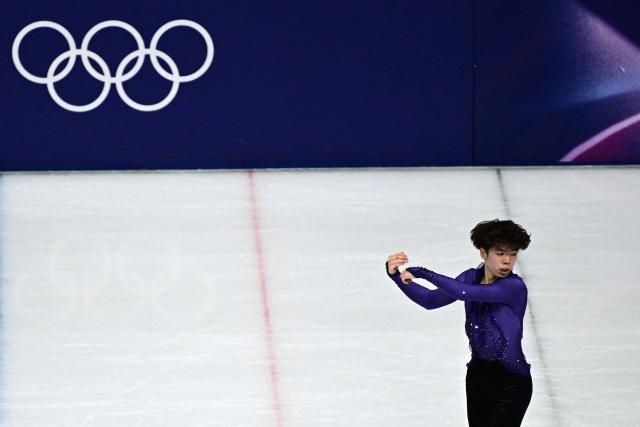 Japan's Shun Sato competes in the figure skating men's singles short program during the Milano Cortina 2026 Winter Olympic Games at Milano Ice Skating Arena in Milan on February 10, 2026. (Photo by JULIEN DE ROSA / AFP)