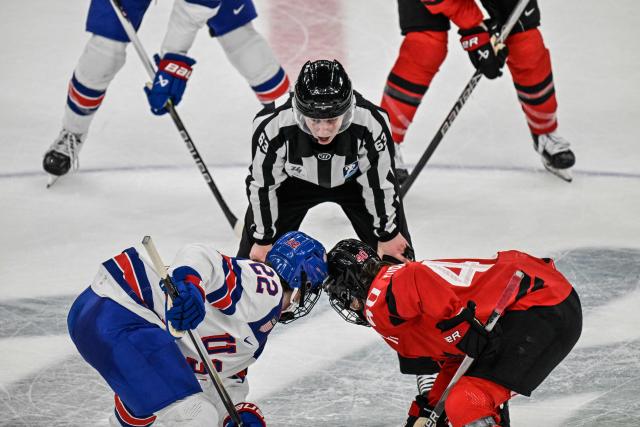 TOPSHOT - USA's forward #22 Tessa Janecke (L) and Canada's forward #40 Blayre Turnbull (R) prepare for a play   during the women's preliminary round Group A Ice Hockey match between Canada and USA at the Milano Santagiulia Ice Hockey Arena during the Milano Cortina 2026 Winter Olympic Games in Milan, on February 10, 2026. (Photo by Alexander NEMENOV / AFP)