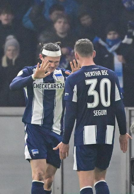 Hertha Berlin's German forward #11 Fabian Reese celebrates scoring the 1-1 goal with his teammate Hertha Berlin's German midfielder #30 Paul Seguin (R) during the German Cup (DFB-Pokal) quarter-final football match between Hertha Berlin and SC Freiburg in Berlin on February 10, 2026. (Photo by John MACDOUGALL / AFP) / DFL REGULATIONS PROHIBIT ANY USE OF PHOTOGRAPHS AS IMAGE SEQUENCES AND/OR QUASI-VIDEO  ALTERNATIVE CROP