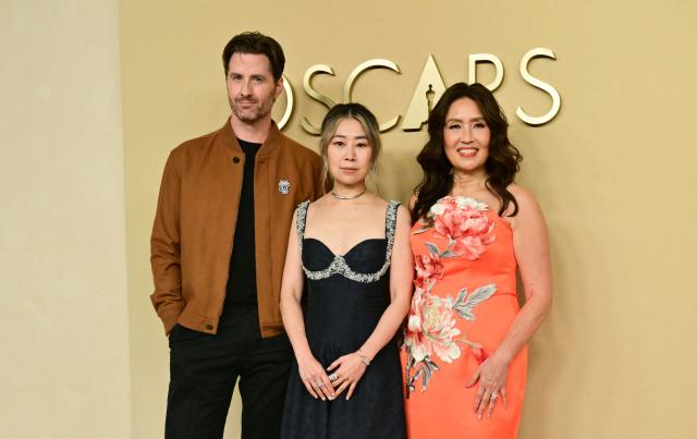 (L-R) US director and illustrator Chris Appelhans, South Korean film director Maggie Kang and producer Michelle  L.M. Wong attend the 98th Oscars Nominees Luncheon at the Beverly Hilton hotel in Beverly Hills, California on February 10, 2026. (Photo by Frederic J. Brown / AFP)