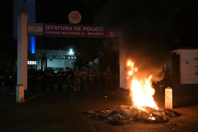 Santa Fe provincial penitentiary police officers guard the headquarters during a police protest demanding better salaries and labor conditions in front of their command in Rosario, Santa Fe province, Argentina early on February 11, 2026. Several dozen Argentine police officers rebelled in demand of better pay and mental health care in the city of Rosario, the country's most crime-ridden city, in protests that continued into the night of February 10, 2026, after escalating the previous day. (Photo by Juan MABROMATA / AFP)