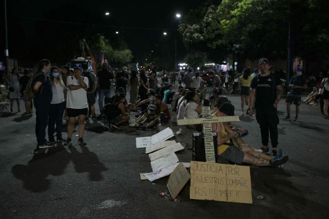 A cross with the names of deceased persons is seen during a police protest demanding better salaries and labor conditions in Rosario, Santa Fe province, Argentina early on February 11, 2026. Several dozen Argentine police officers rebelled in demand of better pay and mental health care in the city of Rosario, the country's most crime-ridden city, in protests that continued into the night of February 10, 2026, after escalating the previous day. (Photo by Juan MABROMATA / AFP)